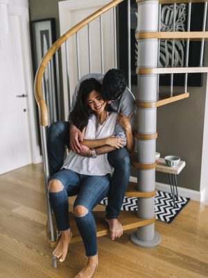 romantic-young-couple-sitting-spiral-staircase